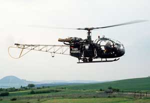 Right side view of an Aerospatiale Alouette II light utility helicopter in flight