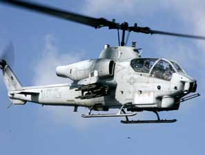 Low angle right side view of an incoming Marine Bell AH-1 SuperCobra attack helictoper