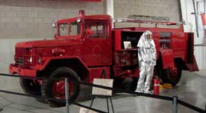 Front left side view of a restored M530 Kaiser JEEP 6x6 firefighting vehicle; color