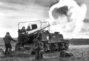 The M12 Gun Motor Carriage firing; note gunner in cover