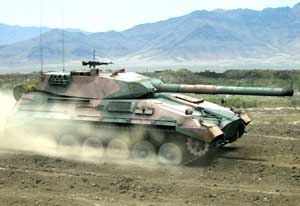 Front right side view of the TAM tank at speed