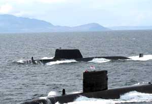 The HMS Astute submarine with the HMS Triumph in the foreground