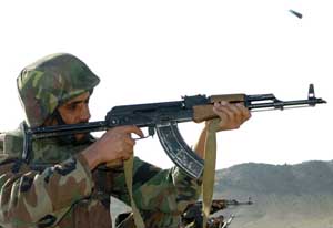 A solider fires his AKMS assault rifle