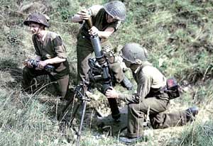 A Canadian mortar team at work with their Ordnance ML 3-inch in 1944; color