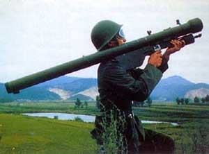 Side profile view of a soldier holding an SA-7 Grail missile launcher; color